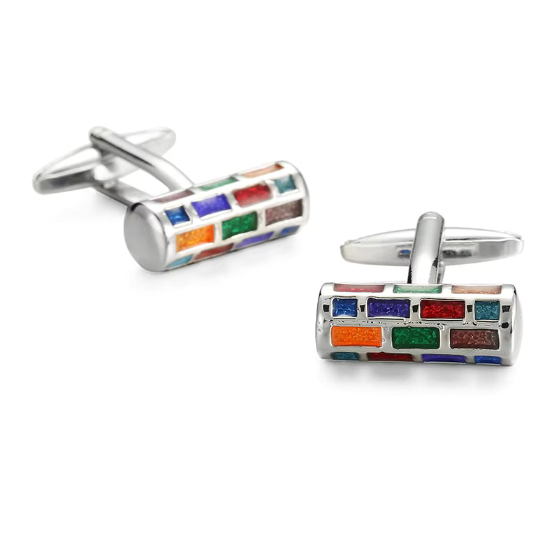 Colorful cylindrical cufflinks on a white background